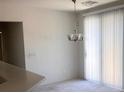Bright dining area with modern lighting and natural light streaming through vertical blinds at 6158 Calm Breeze Ave # 101, Las Vegas, NV 89108