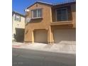 Exterior view of a two-story home with attached garage, and a small upper balcony at 6158 Calm Breeze Ave # 101, Las Vegas, NV 89108