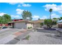 Well-maintained single-story home with a two-car garage, desert landscaping, and a brick-paved walkway at 6408 Shawnee Pl, Las Vegas, NV 89107