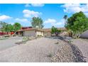 Single-story home with desert landscaping and a driveway leading to an attached two-car garage at 6408 Shawnee Pl, Las Vegas, NV 89107