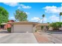 Charming single-story home with a well-maintained front yard, desert landscaping, and a two-car garage at 6408 Shawnee Pl, Las Vegas, NV 89107