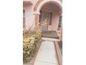 Well-lit home entrance with stone archway and walkway at 6561 Avon Ct, Las Vegas, NV 89108