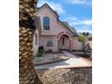 Charming two-story home with a unique archway entrance and a well-maintained front yard landscape at 6561 Avon Ct, Las Vegas, NV 89108