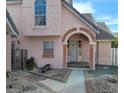 Charming two-story home with a unique archway entrance and a well-maintained front yard landscape at 6561 Avon Ct, Las Vegas, NV 89108