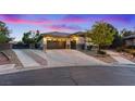 Well maintained house with a three-car garage and gated driveway on a paved street at 6907 Kelp Ledge Ct, Las Vegas, NV 89131