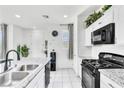 Bright kitchen features granite countertops, stainless appliances and white cabinets at 694 Last Dance Pl, Henderson, NV 89011