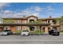 Beautiful building exterior with covered parking, nice landscaping, and visible unit numbers for easy navigation at 7701 W Robindale Rd # 206, Las Vegas, NV 89113