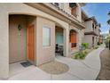 Attractive building exterior, featuring covered entryway, stone accents, and desert landscaping around walkway at 7701 W Robindale Rd # 206, Las Vegas, NV 89113