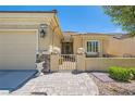 Close up of a charming single-story home featuring a cozy front entrance and two-car garage at 7720 Fruit Dove St, North Las Vegas, NV 89084