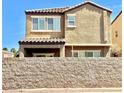 Two-story home with a stucco and tile roof, a covered patio, and a block wall in the back at 81 Sertata Ct, Henderson, NV 89074