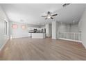 Spacious living room with wood floors, fan, and abundant natural light at 10617 Tuckermans Ave, Las Vegas, NV 89129