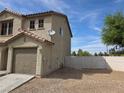 Side view of a home with a one-car garage and fully fenced gravel backyard at 1144 Black Cherry St, Las Vegas, NV 89142