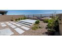 Backyard featuring desert landscaping, patio area, gravel, and a view of the neighborhood at 12524 Skylight View St, Las Vegas, NV 89138