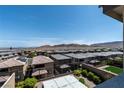 View of backyard and neighborhood featuring desert landscaping, and mountain views in the distance at 12524 Skylight View St, Las Vegas, NV 89138