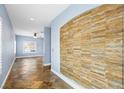 Inviting hallway featuring decorative stone wall and tiled flooring at 224 Devotion Ct, Henderson, NV 89052