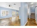 Bright living room boasting tiled floors, windows with shutters, and staircase at 224 Devotion Ct, Henderson, NV 89052