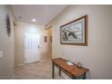 Warm and inviting foyer featuring tile flooring, a wooden console table, and artwork at 2539 Stardust Valley Dr, Henderson, NV 89044