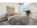 Cozy bedroom featuring neutral decor, a comfortable bed, and a large window with natural light at 2838 Geary Pl # 4002, Las Vegas, NV 89109