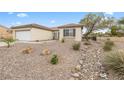 Charming single-story home with low-maintenance desert landscaping, mature trees, and a convenient two-car garage at 2999 Gettysburg Ave, Henderson, NV 89052