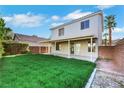 Expansive backyard featuring lush green grass and a covered patio area for outdoor enjoyment at 3644 Shanagolden St, Las Vegas, NV 89129