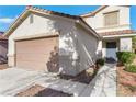 Attractive home exterior featuring a two-car garage, neutral paint, and tiled roof at 3644 Shanagolden St, Las Vegas, NV 89129