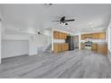 Open-concept living room features hardwood floors, natural lighting, and ceiling fan at 3644 Shanagolden St, Las Vegas, NV 89129