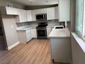 Modern kitchen featuring stainless steel appliances, light counter tops and ample white cabinetry at 3700 Hickey Ave, North Las Vegas, NV 89030