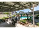 Inviting patio with outdoor cooking station, seating, and garden, creating an ideal space for relaxation at 386 Summer Creek Ct, Henderson, NV 89002