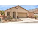 Charming single-story home featuring a low maintenance front yard and attached two car garage at 4071 Blue Manor Ln, North Las Vegas, NV 89032
