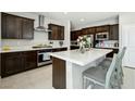 Modern kitchen features stainless steel appliances, a spacious island and lots of cabinets for storage at 4630 Adonis Blue St, North Las Vegas, NV 89031