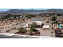 Views of a large lot with single story house, basketball court, metal outbuilding, and inground pool in neighborhood at 5315 N Fort Apache Rd, Las Vegas, NV 89149