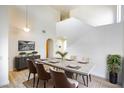 Formal dining room with modern table set and decor, as well as contemporary light fixture at 5345 Tustin Hills St, North Las Vegas, NV 89081