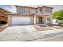 Charming two-story home with a well-manicured lawn, covered porch, and two car garage at 5345 Tustin Hills St, North Las Vegas, NV 89081