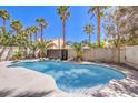 Backyard swimming pool surrounded by palm trees and a privacy wall at 5436 Red Sun Dr, Las Vegas, NV 89149