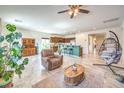 Spacious living room with tile flooring, comfortable furniture, and easy access to the kitchen at 5500 E Volterra Dr, Pahrump, NV 89061