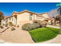 Charming single-story home with desert landscaping and green lawn with easy access to the street at 5575 Cresent Valley St, Las Vegas, NV 89148