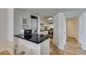 Bright kitchen with stainless steel appliances and modern bar seating area at 5725 Smoke Ranch Rd # A, Las Vegas, NV 89108