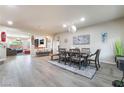 Open-concept dining room featuring modern lighting, wood floors, and stylish decor at 6047 Ancient Peaks Ave, Las Vegas, NV 89141