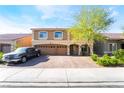Attractive two-story home with a well-manicured front yard and spacious three-car garage at 6047 Ancient Peaks Ave, Las Vegas, NV 89141