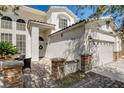 Inviting two-story home with a brick paver patio and manicured landscaping at 6236 Desert Haven Rd, Las Vegas, NV 89130