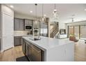 Spacious kitchen with stainless appliances and a waterfall island, seamlessly flowing into the living area at 6433 Farness St, Las Vegas, NV 89135