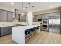 Modern kitchen with gray cabinetry, stainless steel appliances, and a large center island at 6433 Farness St, Las Vegas, NV 89135