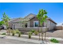 Beautiful view of the home's exterior showcasing desert landscaping and modern architectural design at 689 Moonstone Beach Pl, Henderson, NV 89011