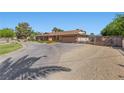 Long driveway leading to a single-story home with an attached garage and gated parking area at 7350 W Rome Blvd, Las Vegas, NV 89131