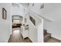 Bright entryway featuring a staircase with glass accents, sleek floors, and tasteful decor at 7361 Ringquist St, Las Vegas, NV 89148