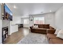 Cozy living room with modern flooring, a comfortable sofa, and large windows at 7361 Ringquist St, Las Vegas, NV 89148
