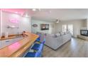 Entertaining space with bar, ample seating, fireplace and 'Good Vibes Only' neon art at 9124 Sapphire Ridge Ave, Las Vegas, NV 89129