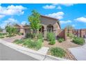 Beautiful home exterior featuring low maintenance landscaping and decorative brickwork on a sunny day at 9590 Smiley Creek St, Las Vegas, NV 89178