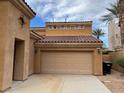 Attached two-car garage with a tile roof, complementing the home's architectural style at 1091 Casa Palermo Cir, Henderson, NV 89011
