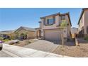 Charming two-story home featuring an attached garage and a beautifully paved driveway at 10933 Sageview Ave, Las Vegas, NV 89166
